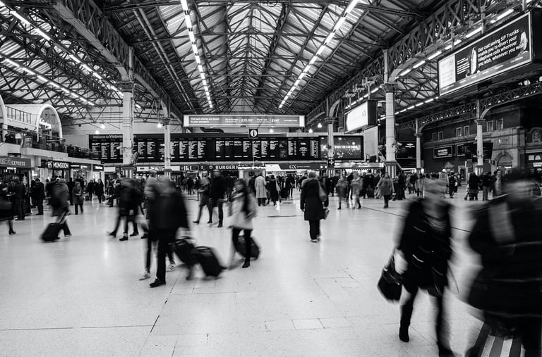 a group of people walking through a train station