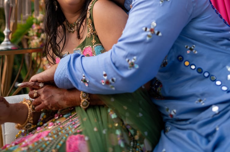 a man and woman in a colorful dress and a man in a blue suit