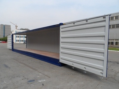 a container container with a door open and a wooden floor