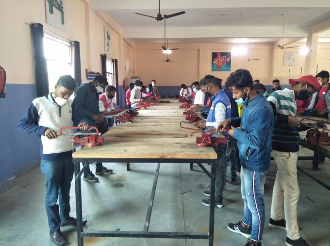 a group of people standing around a table with a table with a table top
