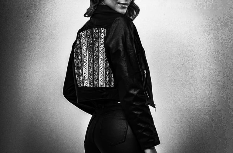 Modelo en blanco y negro con chaqueta oscura y arte en la espalda de Sandra Amaya