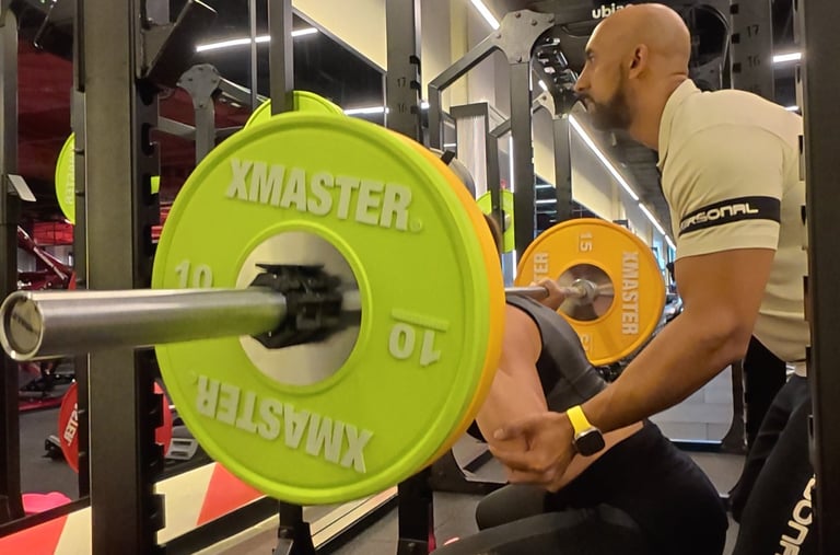 a man is squatting on a bench with a green plate