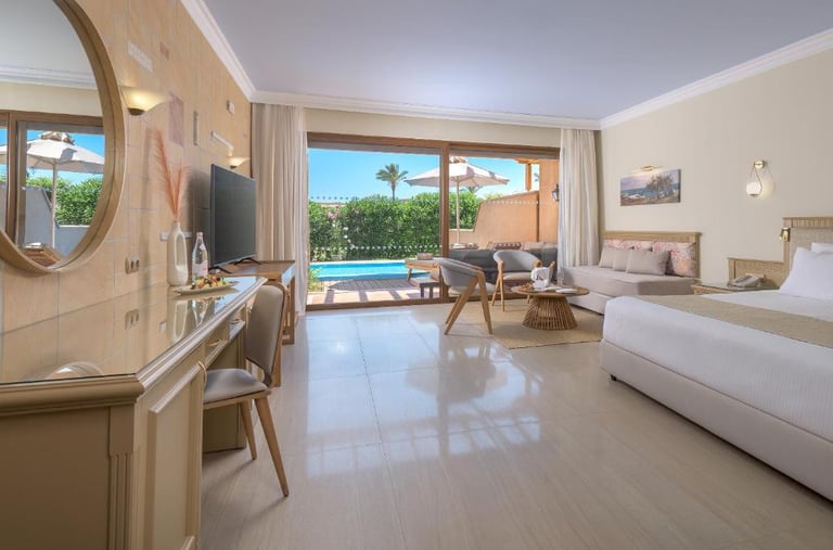 Luxury hotel room with a private pool view, featuring modern furniture and an elegant terrace.