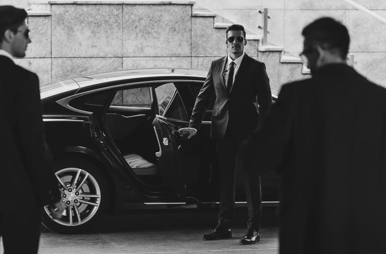 a bodyguard is standing in front of a car