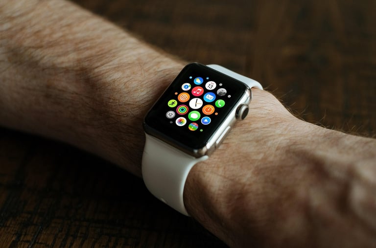 a person holding a smart watch in their hand