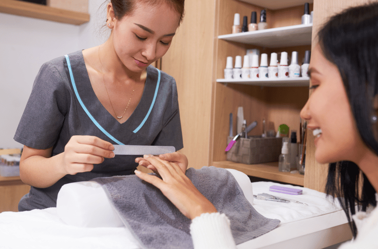 A customer is enjoying a nail treatment session at a professional nail salon