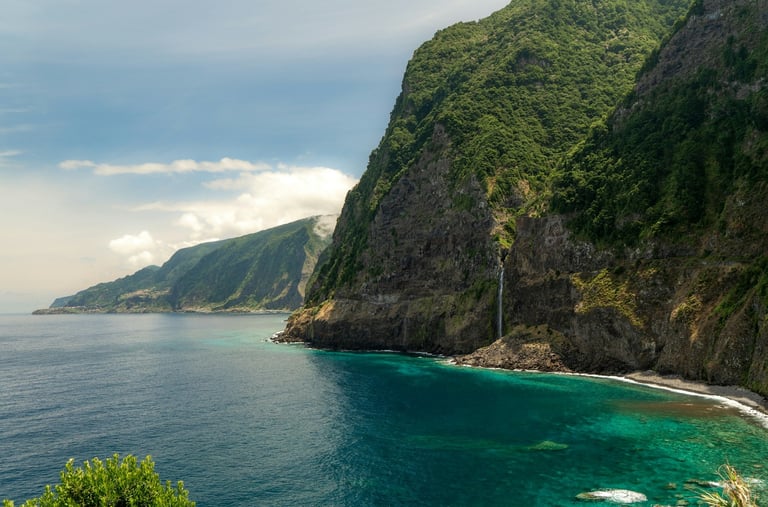 Green cliffs on Madeira Island above the Atlantic Ocean.