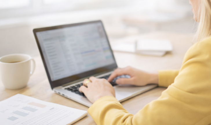 Hands typing on laptop