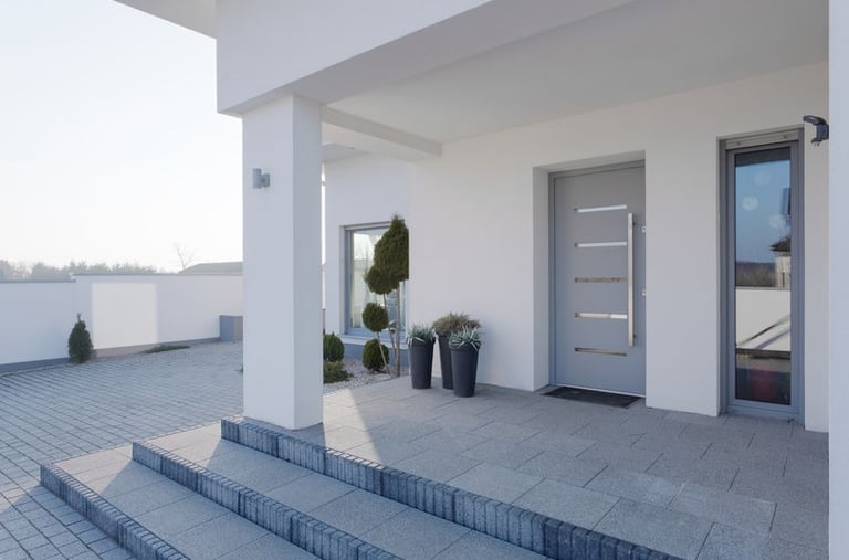 a house with a large front door and steps leading to the front door