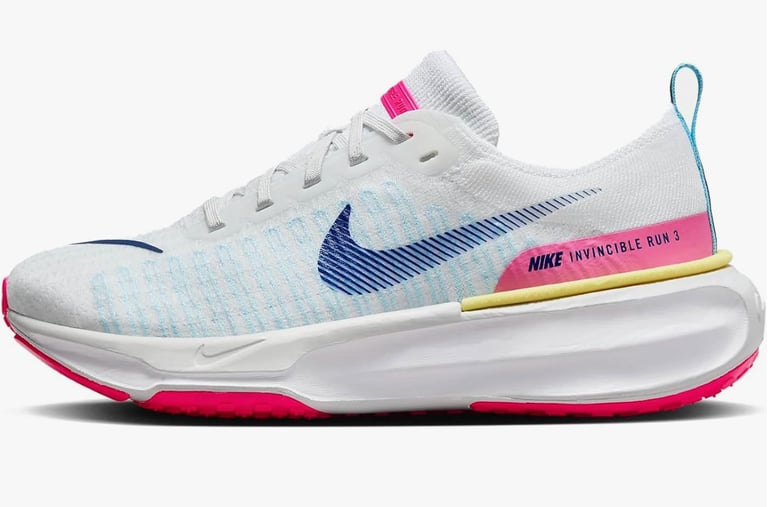 Nike Invincible 3 running shoe in bright mango and hyper pink colorway on pavement during outdoor wear test.