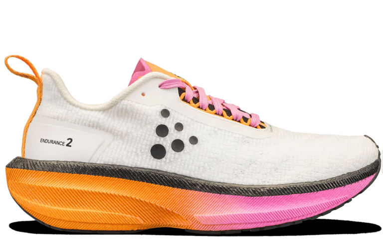 Craft Endurance 2 running shoe in Ash White and Fuchsia colorway displayed outdoors for a tempo-run focused review.