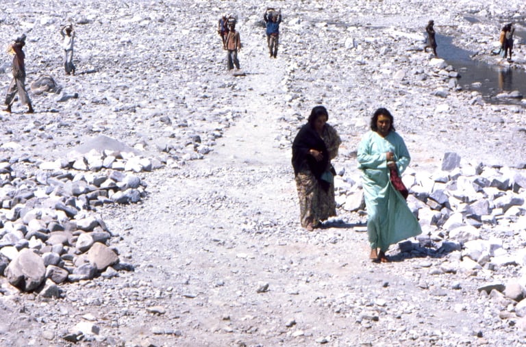 Babaji walks along a path on the river Gautam Ganga