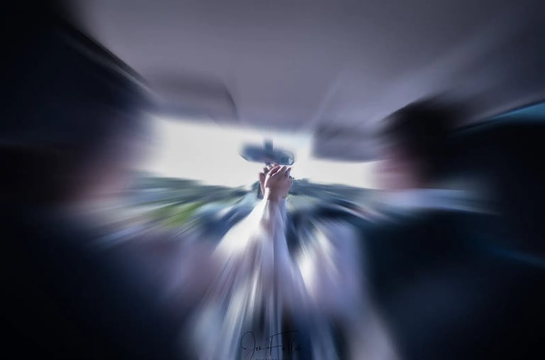 wedding couple holding hands in their car