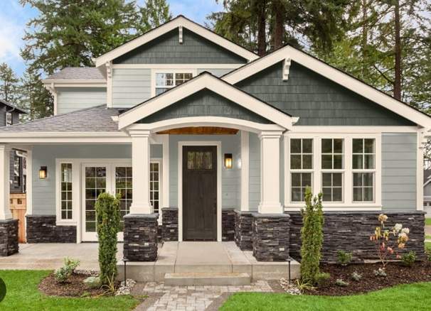 Exterior of a residential home with a front porch and gabled roof.