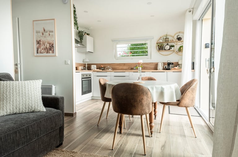 Salon lumineux et moderne avec cuisine ouverte dans un appartement spacieux.