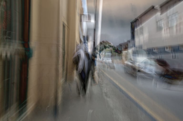 Abstract Cape Town street photograph showing a layered impression of a woman in a headscarf walking past cars and buildings