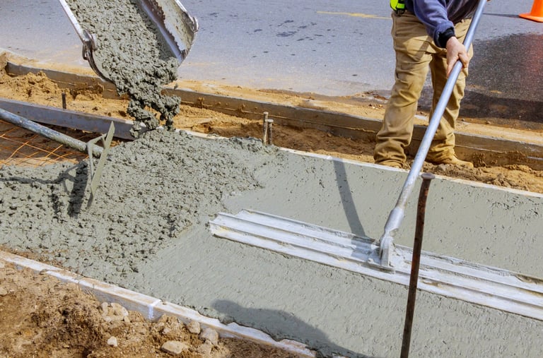 a man is pouring concrete into a concrete slab