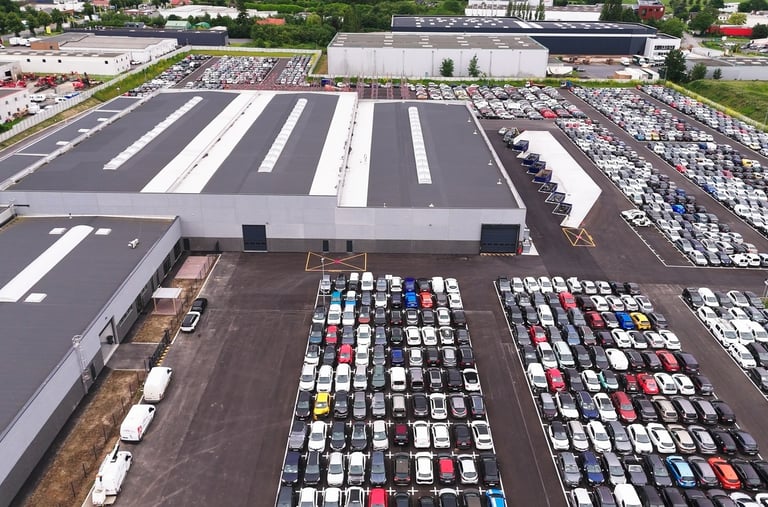 a parking lot with cars parked in front of a building