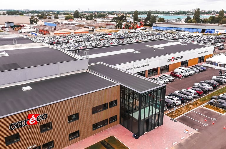 a large building with a lot of cars parked in front of it