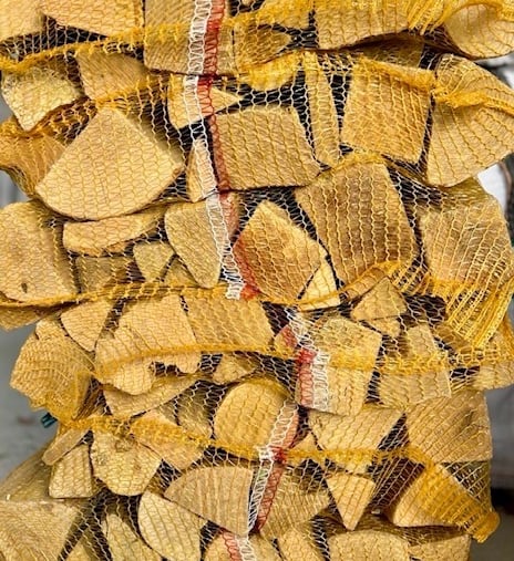 Kiln dried hardwood logs in nets