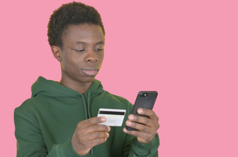 a young man holding a credit card for mobile payment set up