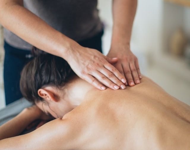 a woman getting a massage at a massager