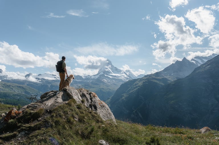 a person standing on a mountain top with a backpack