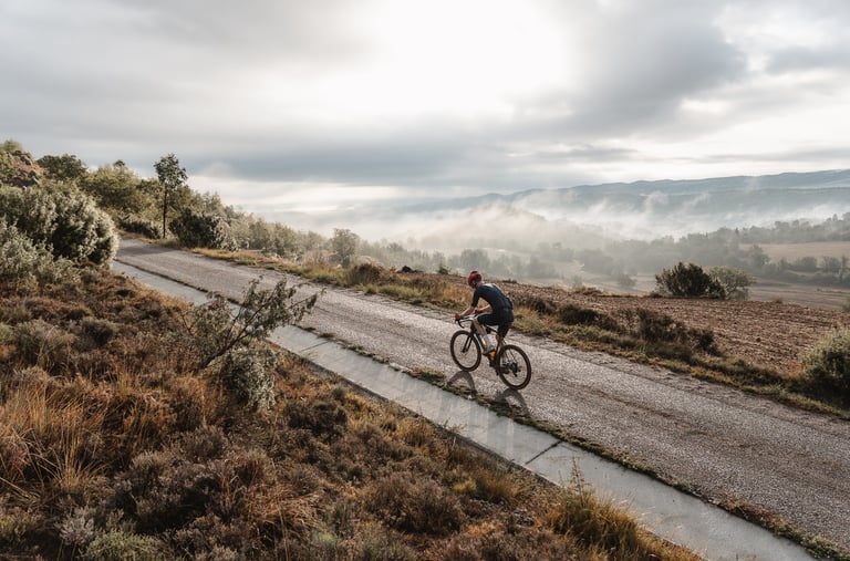a man riding a bicycle down a road