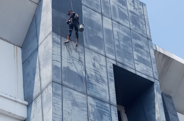 a man on a rope rope with a rope attached to a building