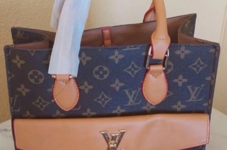 Luxury Louis Vuitton monogram tote bag with tan leather front pocket and gold LV logo hardware.