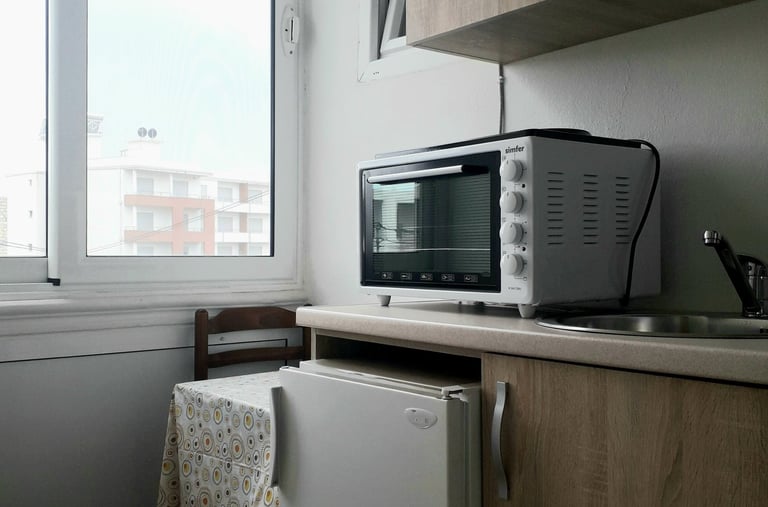 a microwave with a microwave oven and a small table