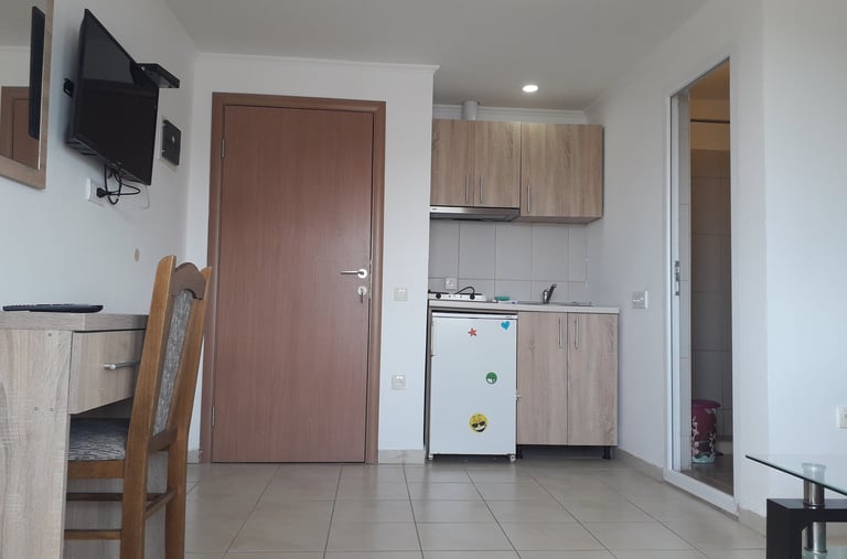 a kitchen with a refrigerator, microwave, and a refrigerator