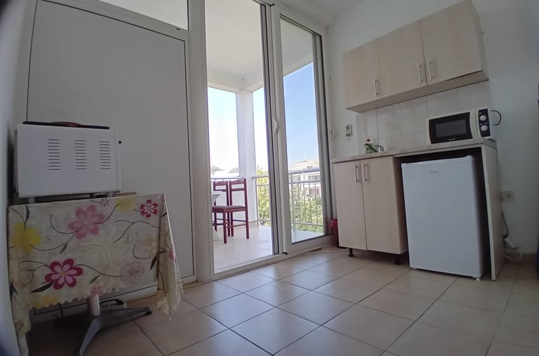 a kitchen with a refrigerator, microwave, and refrigerator freezer