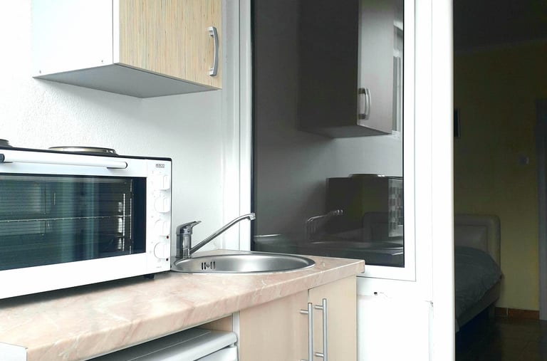 a couch with pillows and a table with a tv