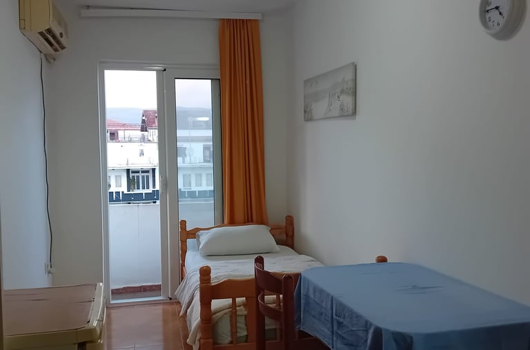 a small room with a bed and a table