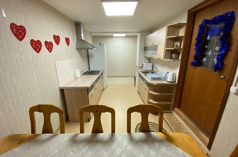 a kitchen with a table and chairs