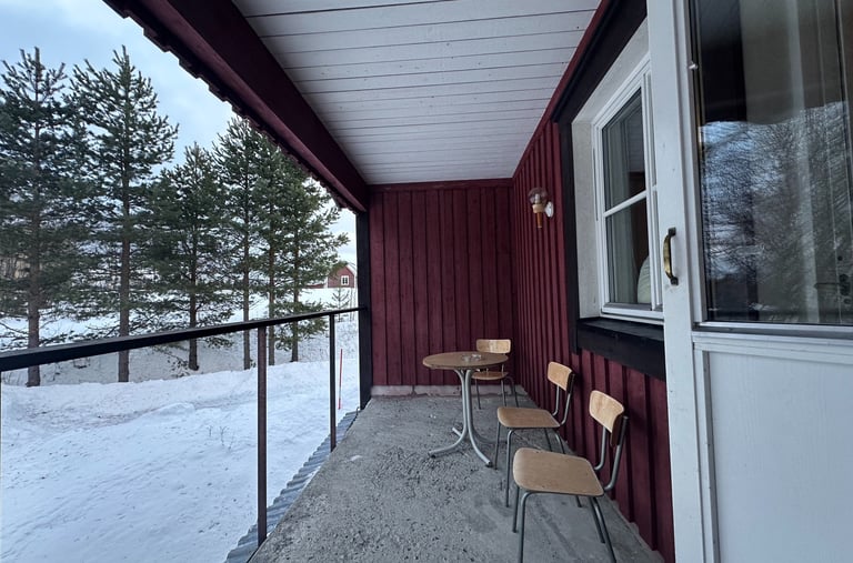 a balcony with chairs and tables