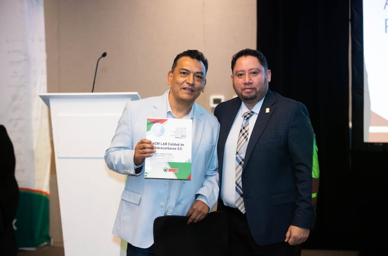 Two professional men holding a certificate at an AMPES event for hydrocarbon quality control.