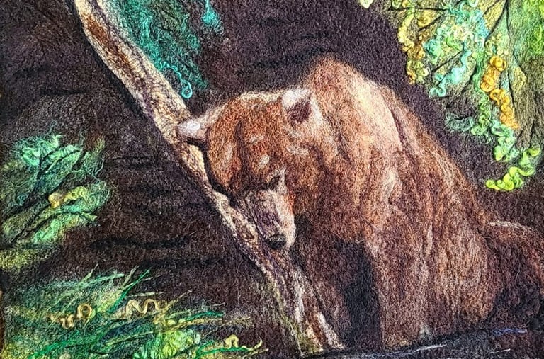 a wool painting of a sleeping brown bear