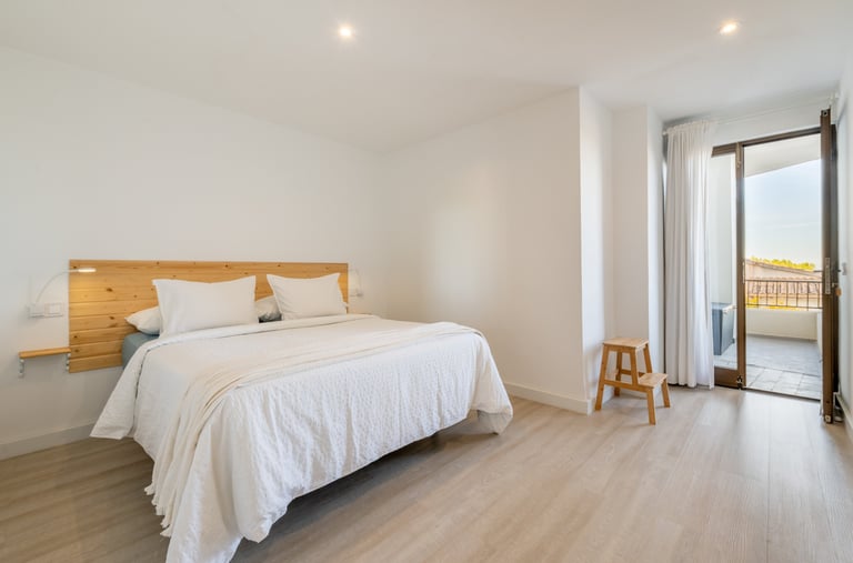 a bedroom with a bed queen size and a wooden headboard