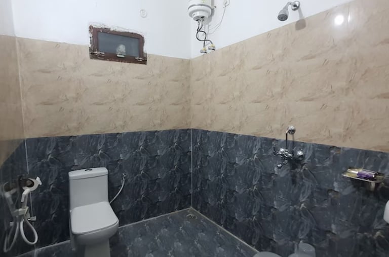 Bathroom at hotel rudra near jolly grant airport