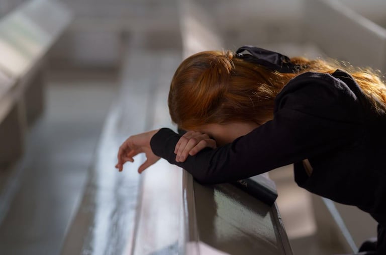 a woman with red hair praying in desperation