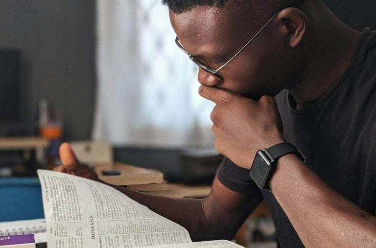 a man sitting at a desk with a bible