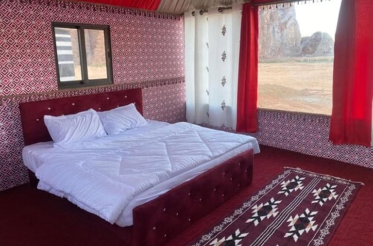 a bed with a red carpet and a red carpet