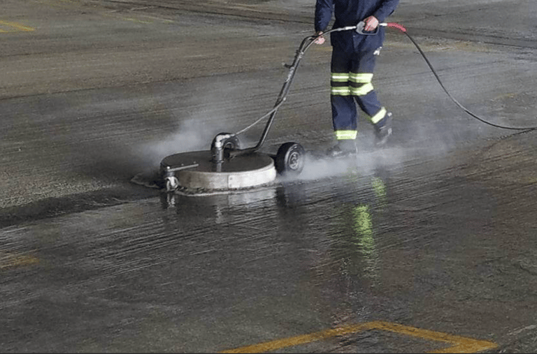 man power washing parking lot