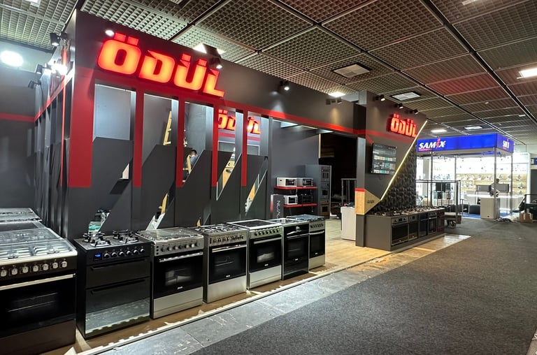 Professional industrial exhibit for kitchen appliances featuring dark aesthetic and functional product placement.