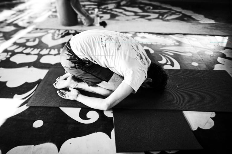 A yoga practitioner executes the Child Pose