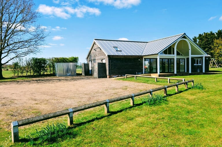 Exterior of Radwinter Pavilion showing the building and parking area in Radwinter near Saffron Walden