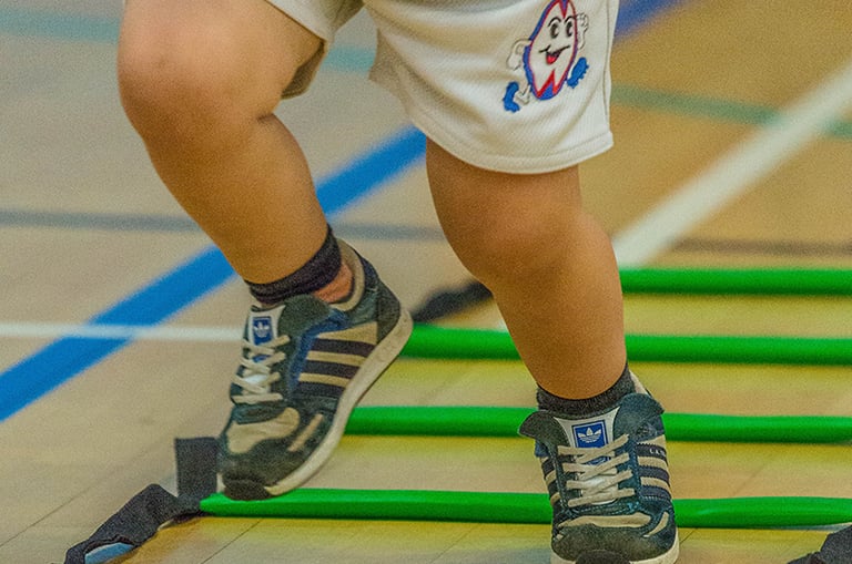 Toddler taking part in Ruggerbugs sports class in Saffron Walden indoor hall