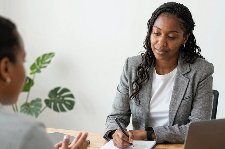 A diverse group of professionals collaborating around a table, reflecting inclusivity and teamwork.